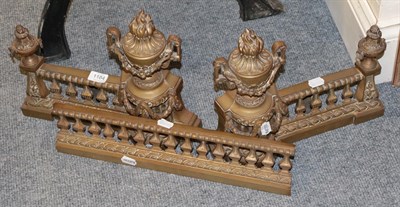 Lot 1184 - A late 19th century gilt brass fire surround with urn finials