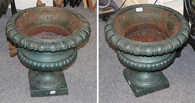 Lot 1186 - Pair of green painted cast iron garden urns