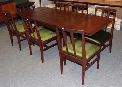 Lot 1192 - A 1970's Danish teak dining suite comprising of dining table, seven dining chairs, sideboard...