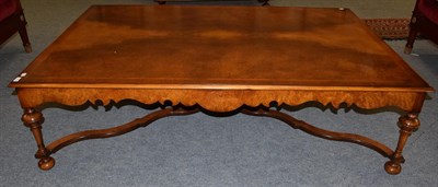 Lot 1196 - A 20th century walnut veneered feather banded coffee table of large proportions with turned...