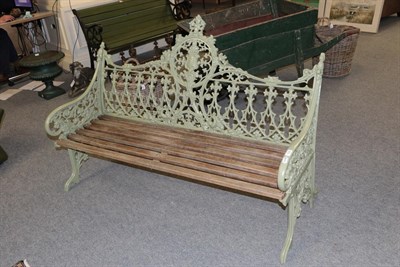 Lot 1222 - A painted cast metal garden bench, after a Coalbrookdale original, with foliate and strapwork...