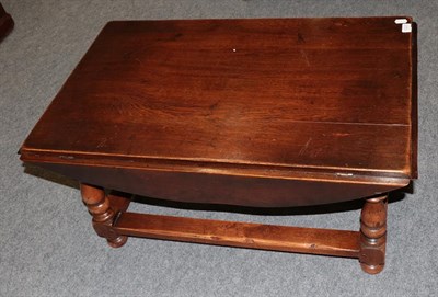 Lot 1223 - A reproduction oak drop leaf coffee table, 92cm wide