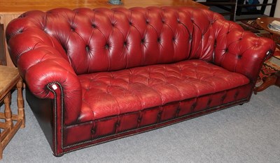 Lot 1224 - A red leather Chesterfield sofa
