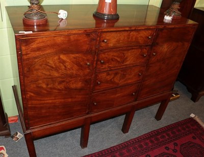 Lot 1228 - A mahogany sideboard with four central drawers flanked by two cupboards doors, 107cm by 137cm...