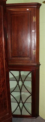 Lot 1239 - An early 19th century mahogany corner cupboard together with a George III oak hanging corner...