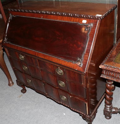 Lot 1253 - An early 20th century Chippendale style carved mahogany bureau, gadrooned apron, on claw and...