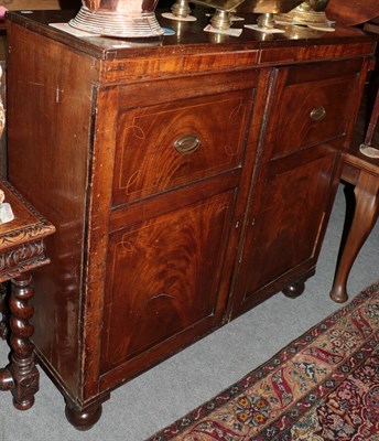 Lot 1257 - A mahogany cupboard, 19th century and adapted, with two cupboard doors enclosing shelves and...