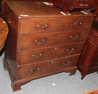 Lot 1266 - An George III oak chest of drawers, two short over three long drawers raised on bracket feet,...
