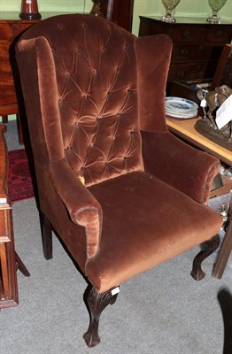 Lot 1275 - Georgian style wing armchair raised on ball and claw feet