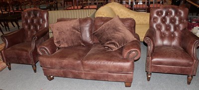 Lot 1285 - A John Lewis brown two-seater settee together with two brown-button back armchairs