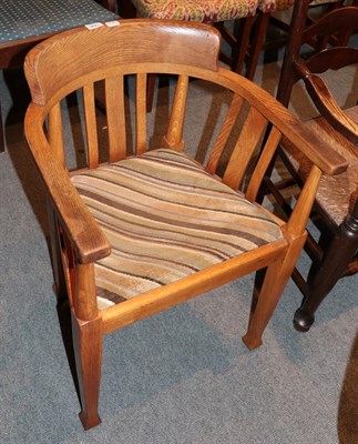 Lot 1290 - An early 20th century oak office armchair with striped seat, 56cm wide