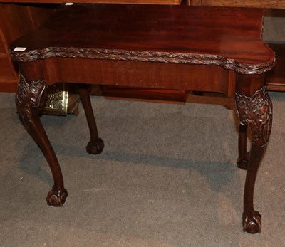 Lot 1298 - George II style carved mahogany fold-over card table with gaming wells, 88cm wide