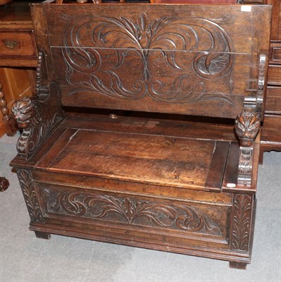 Lot 1299 - An early 20th century carved oak Monks' bench