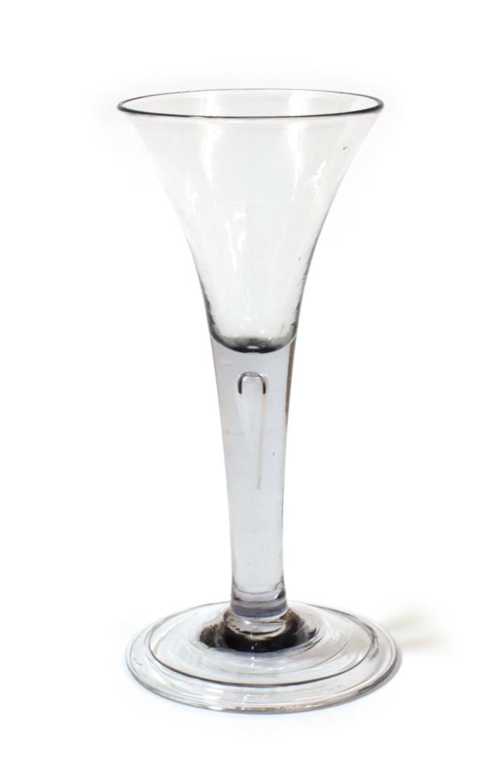 Lot 1003 - A Large Wine Glass, circa 1750, the trumpet bowl on a plain stem with air tear and folded foot,...