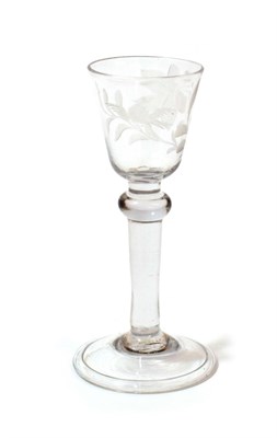 Lot 1005 - A Wine Glass, circa 1750, the rounded funnel bowl engraved with a bird and foliage over a ball...