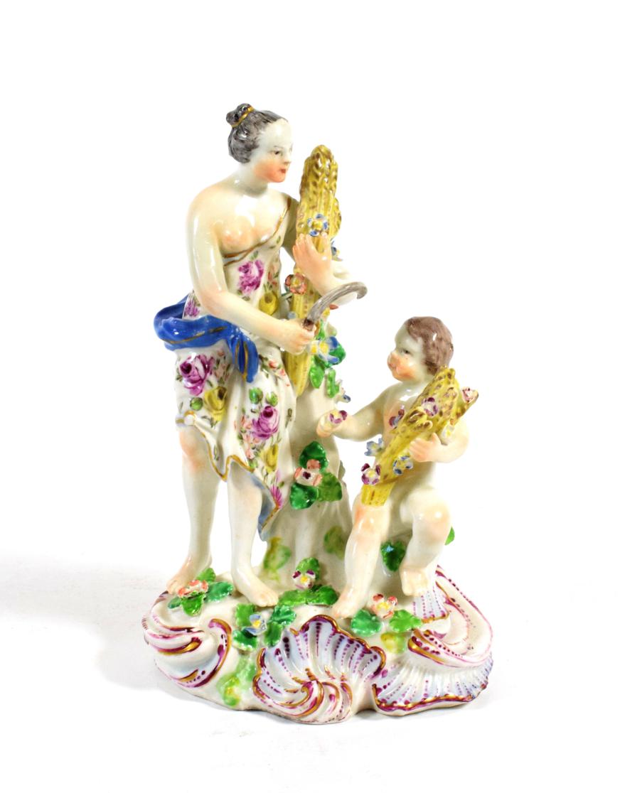 Lot 1020 - A Bow Porcelain Figure Group of Summer, circa 1765, modelled as a classical maiden holding a...