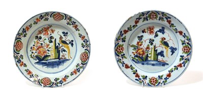 Lot 1035 - ^ A Pair of Lambeth Delft Dishes, circa 1760, painted in colours with a parrot perched amongst...