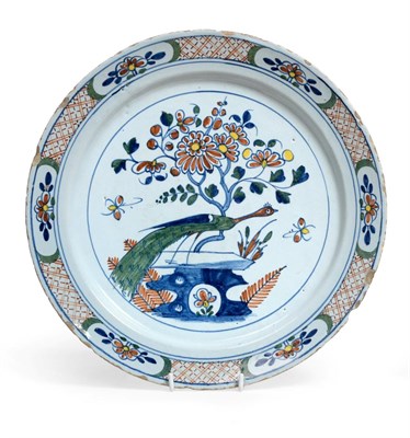 Lot 1038 - ^ An English Delft Dish, circa 1750, painted in colours with a pheasant perched on rockwork...