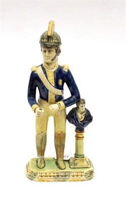 Lot 1064 - ^ A Whieldon Type Figure of a Dragoon, circa 1810, standing, a bust on a column at his side, on...