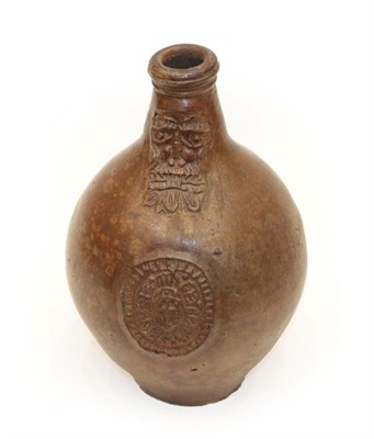 Lot 1075 - A German Stoneware Bellarmine, 17th century, of ovoid form with strap handle, decorated with a...