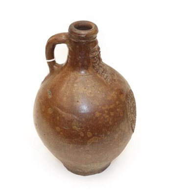Lot 1075 - A German Stoneware Bellarmine, 17th century, of ovoid form with strap handle, decorated with a...