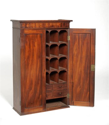 Lot 1384 - A Mahogany Wall Cabinet, 2nd quarter 19th century, with two panel doors enclosing an arrangement of