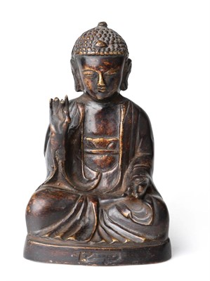 Lot 1112 - A Chinese Bronze Figure of Buddha, Ming Dynasty, probably late 16th century, the cross-legged...