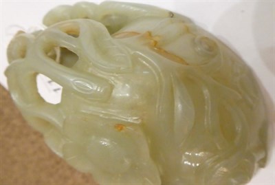 Lot 1116 - A Chinese Jade Libation Cup, in the form of a peach with pierced foliate scroll handle, 12cm...