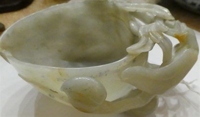 Lot 1117 - A Chinese Jade Libation Cup, of peach form with carved and pierced flowering and fruiting...