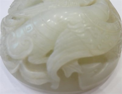 Lot 1118 - A Chinese Jade Oval Plaque, carved with a bird amongst foliage, 9.5cm wide; and A Similar...