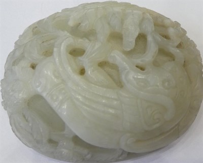 Lot 1118 - A Chinese Jade Oval Plaque, carved with a bird amongst foliage, 9.5cm wide; and A Similar...