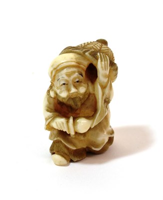 Lot 1131 - A Japanese Ivory Netsuke, Meiji period, as Jurojin carrying a large hat and a peach, signed,...