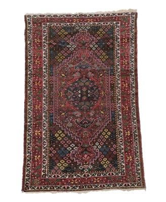 Lot 1178 - Bakhtiari Rug West Iran, circa 1925 The charcoal field with central stepped lozenge framed by...