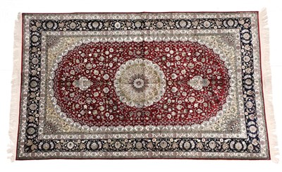Lot 1183 - Modern Chinese Silk Rug The claret field of scrolling vines around a flower head medallion...