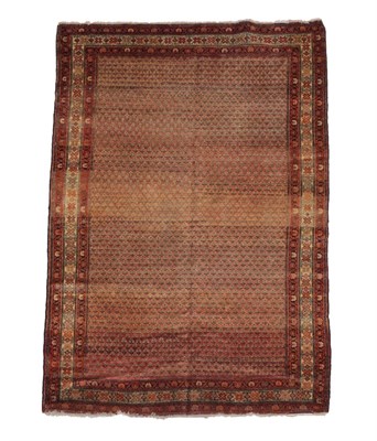 Lot 1193 - Malayir Rug West Iran, circa 1920 The faded coral pink field of stylised plants enclosed by...