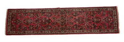 Lot 1201 - Narrow Saroukh Runner West Iran, circa 1970 The candy pink field with naturalistic floral...