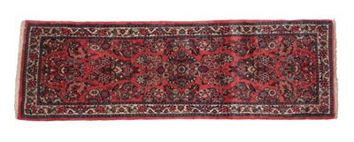 Lot 1202 - Narrow Saroukh Runner West Iran, circa 1970 The candy pink field of floral sprays enclosed by...