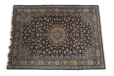 Lot 1208 - Kashan Carpet Central Iran, circa 1960 The deep indigo field of vines around a flower head...