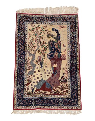 Lot 1210 - Isfahan Pictorial Rug Central Iran, circa 1960 the cream field with two figures beneath a tree...