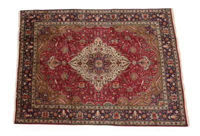 Lot 1218 - Tabriz Carpet Iranian Azerbaijan, circa 1960 The raspberry field of angular vines around an...