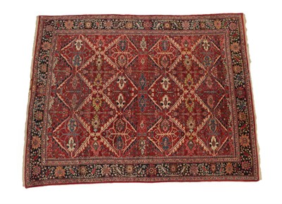 Lot 1227 - Sultanabad Carpet West Iran, circa 1920 The tomato red field of diamond lattice design...