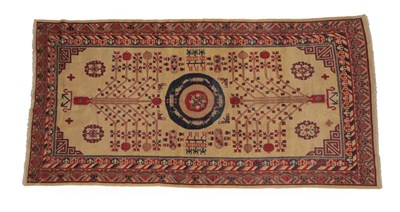 Lot 1238 - Khotan Carpet Chinese Turkestan, circa 1925 The cream field with central roundel flanked by angular