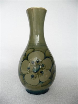 Lot 1408 - A William Moorcroft Vase, decorated with green flowers on a green ground, impressed factory...