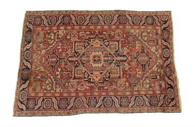 Lot 1239 - Heriz Carpet Iranian Azerbaijan, circa 1900 The terracotta field of angular vines around a...