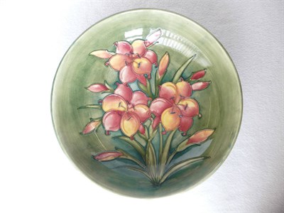 Lot 1410 - A Walter Moorcroft "African Lily" Footed Bowl, on a green ground, impressed factory marks and...