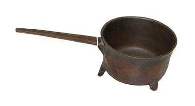 Lot 1263 - A Copper Skillet, possibly 17th century, of cylindrical form with fluted handle and three peg feet