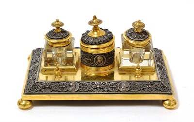 Lot 1274 - A Brass Inkstand, early 19th century, with central circular pot and cover flanked by two glass...