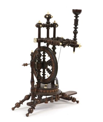 Lot 1282 - A Black Forest Treen Miniature Spinning Wheel, circa 1900, with baluster turned uprights and carved