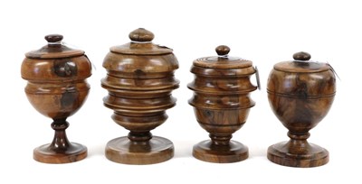 Lot 1283 - A Turned Treen Pedestal Cup and Cover, 19th century, of waisted oval form on a circular socle, 21cm