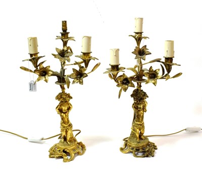 Lot 1290 - A Pair of French Gilt Metal Three-Light Candelabra, in Louis XV style, with foliate branches...